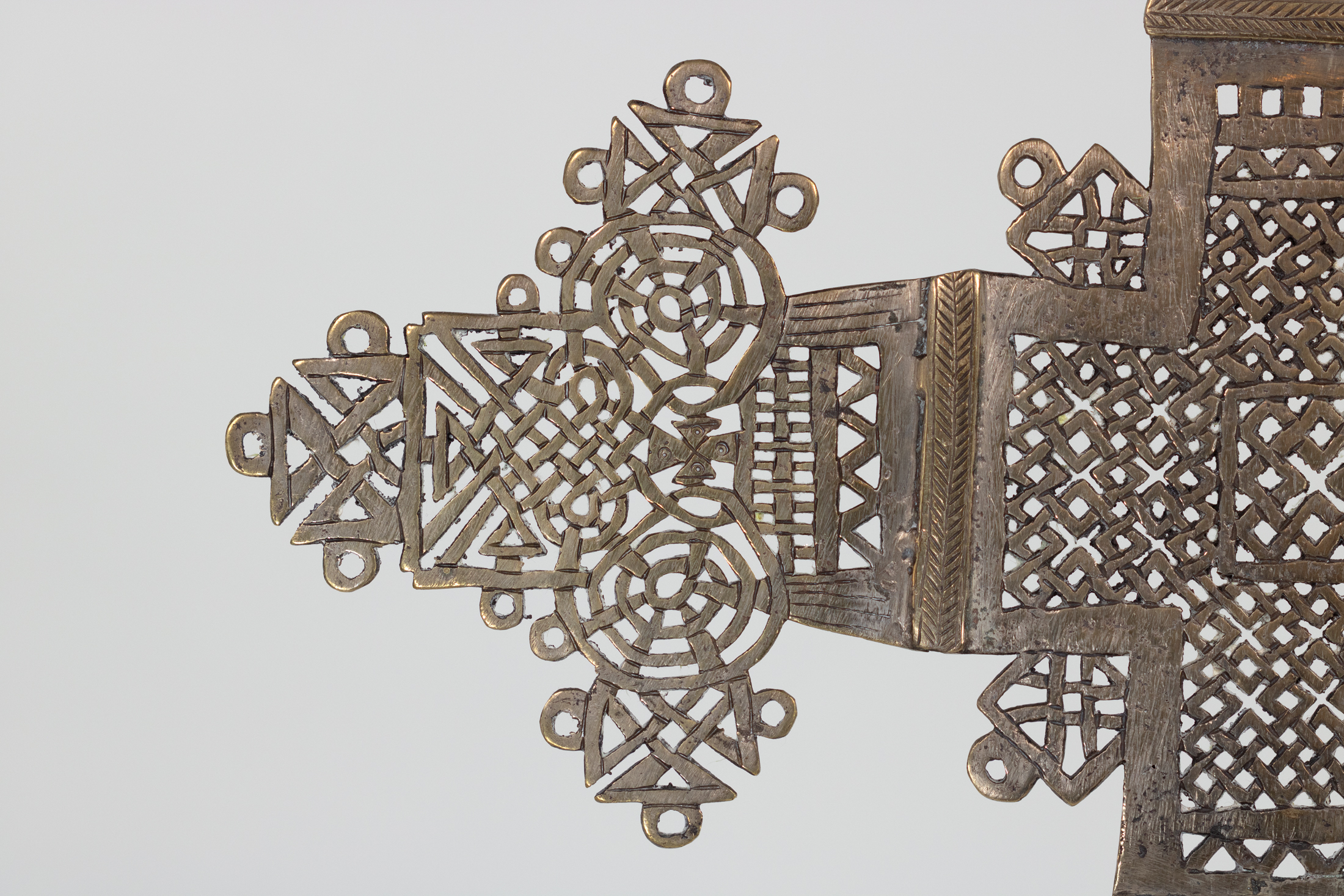 Detail of Ethiopian processional cross left arm terminal in pierced and incised brass
