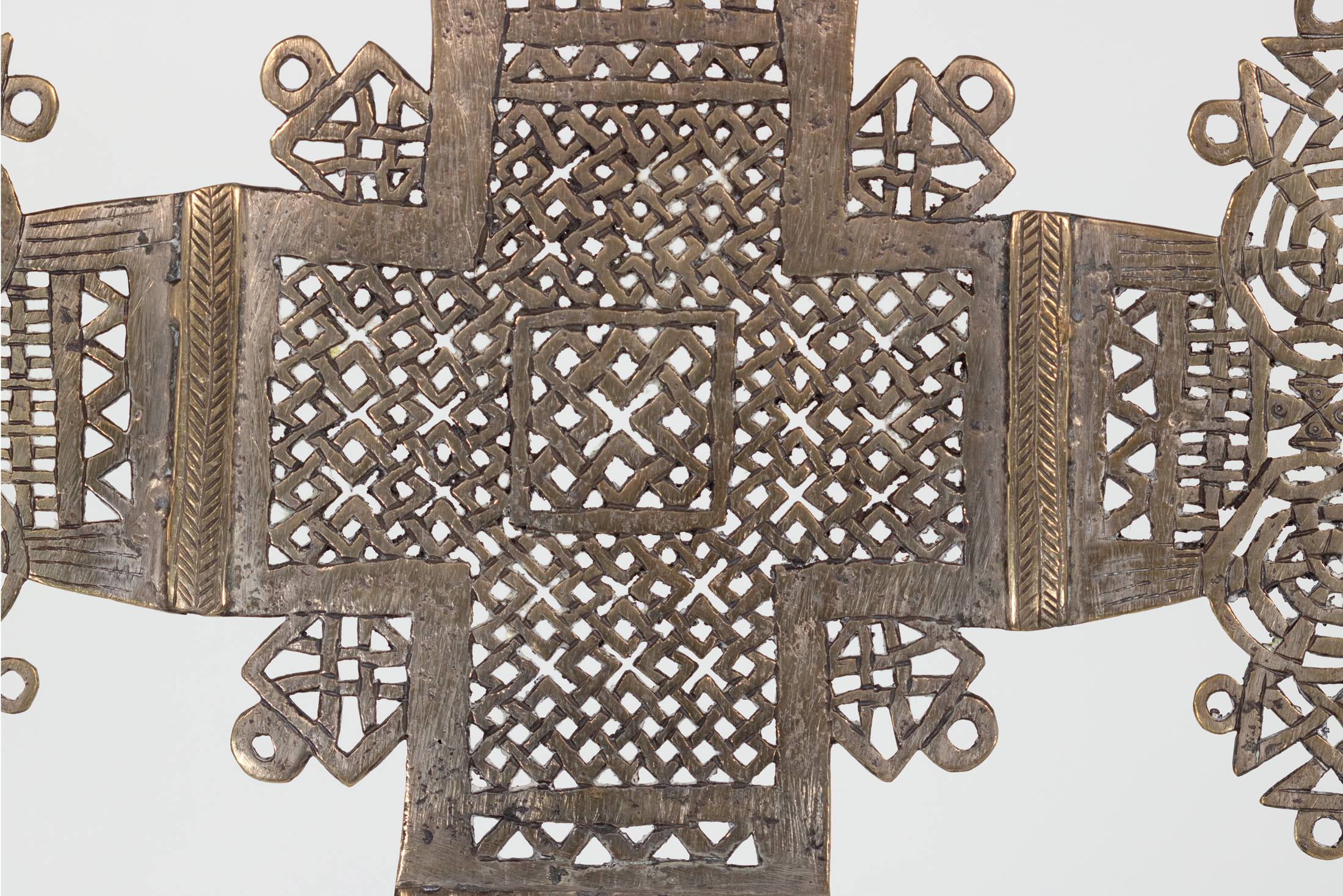 Close detail of Ethiopian processional cross central square with interlaced brass latticework