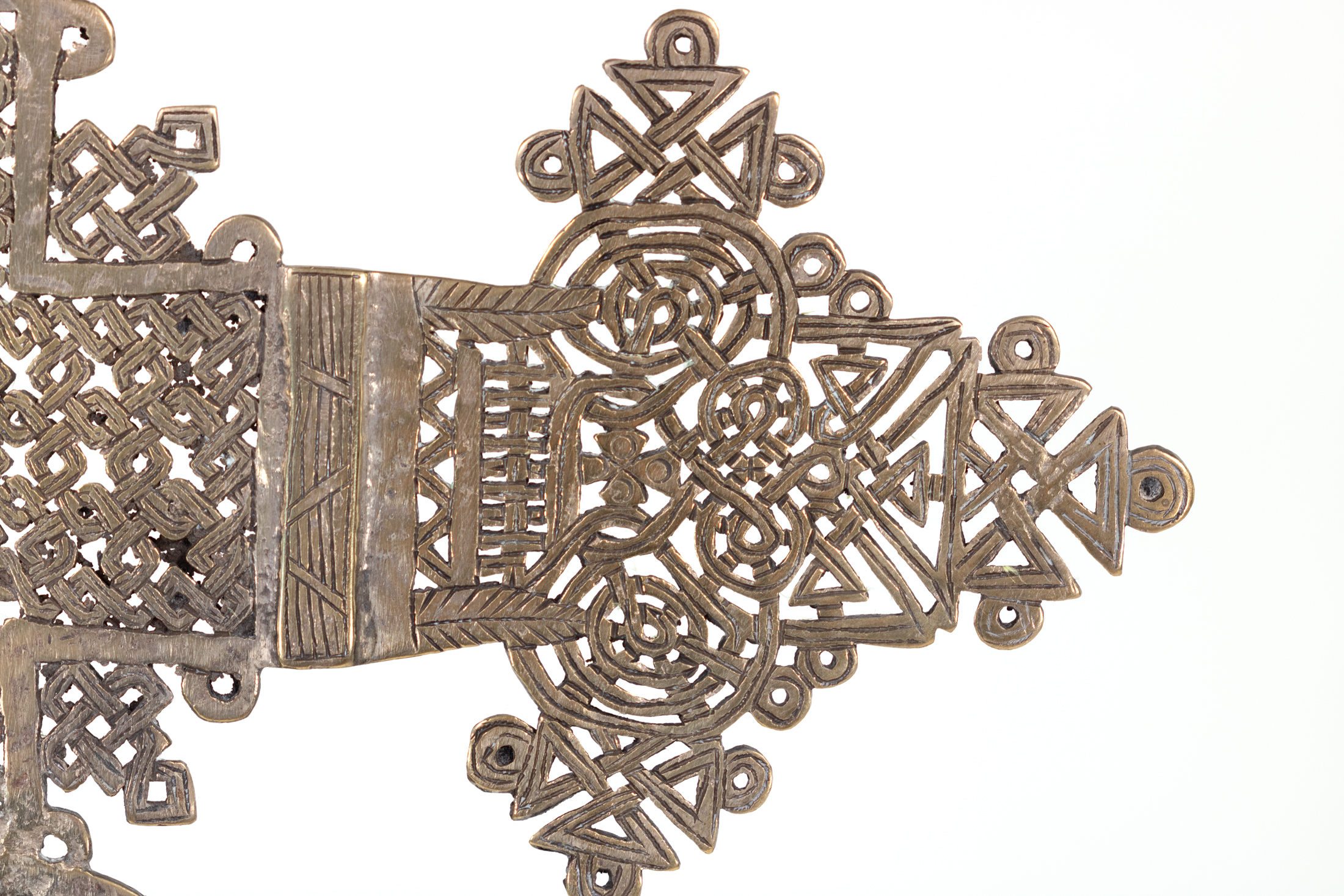 Detail of smaller Ethiopian processional cross right arm terminal in incised openwork brass