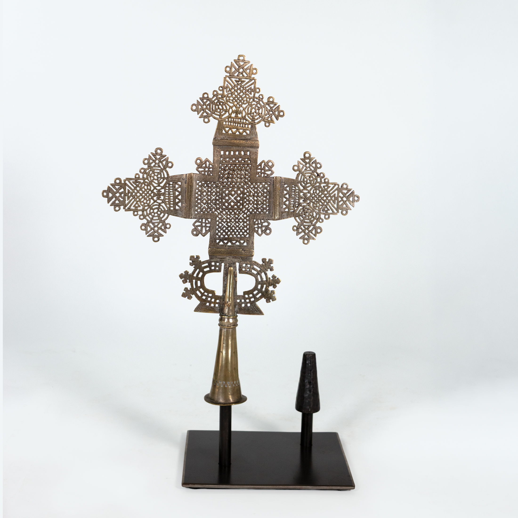 Larger Ethiopian brass processional cross mounted singly on steel display stand